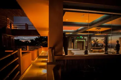 a restaurant with a view of the ocean at night at Hotel Las Islas in Baru