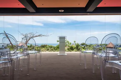 a group of tables and chairs in a room with a window at Hotel Las Islas in Baru