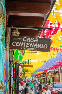 a crowd of people walking down a street in a market at Hotel Casa Centenario Getsemaní in Cartagena de Indias