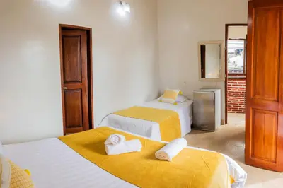 a room with two beds with towels on them at Hotel Casa Centenario Getsemaní in Cartagena de Indias