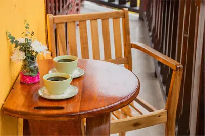 a wooden table with two cups of coffee on it at Hotel Casa Centenario Getsemaní in Cartagena de Indias