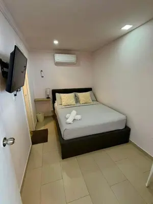 a bedroom with a bed with two towels on it at Apartamentos Cartagena Caribe Suite in Cartagena de Indias