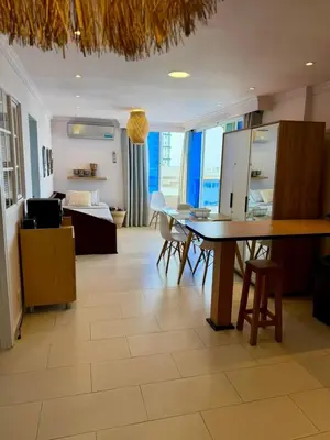 a kitchen and living room with a table and chairs at Apartamentos Cartagena Caribe Suite in Cartagena de Indias