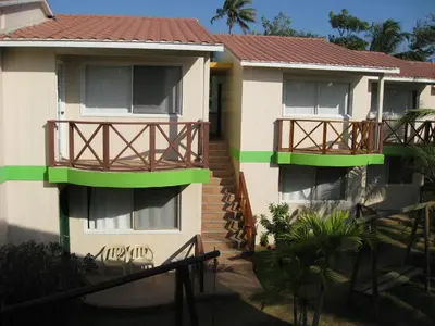 a building with two balconies and a staircase next to it at Hotel Nitana in Coveñas