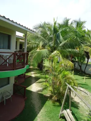a balcony of a house with palm trees at Hotel Nitana in Coveñas