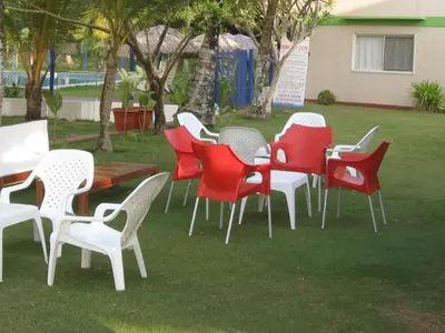 a group of chairs and tables in a yard at Hotel Nitana in Coveñas