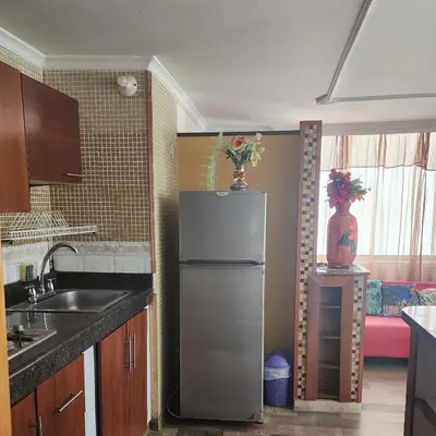 a kitchen with a stainless steel refrigerator in a room at Arriendos Yeny in Cartagena de Indias
