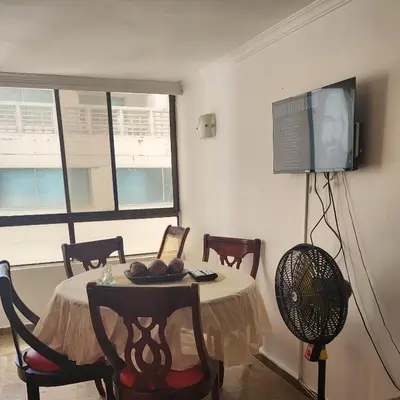 a room with a table with chairs and a fan at Arriendos Yeny in Cartagena de Indias
