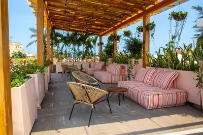 a patio with couches and tables and chairs at La Passion by Masaya Collection in Cartagena de Indias