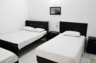 a room with two beds and a picture on the wall at Hotel Villa Colonial By Akel Hotels in Cartagena de Indias