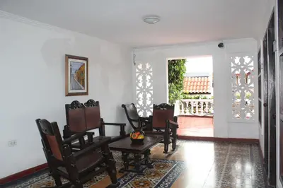 a room with chairs and a table and a door at Hotel Villa Colonial By Akel Hotels in Cartagena de Indias