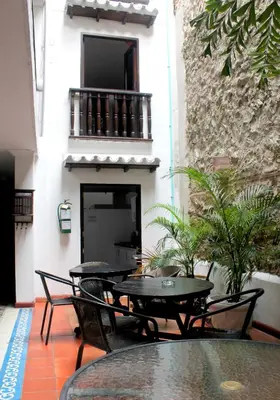 a patio with tables and chairs and a building at Hotel Villa Colonial By Akel Hotels in Cartagena de Indias