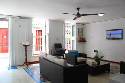 a living room with a couch and chairs and a tv at Hotel Villa Colonial By Akel Hotels in Cartagena de Indias