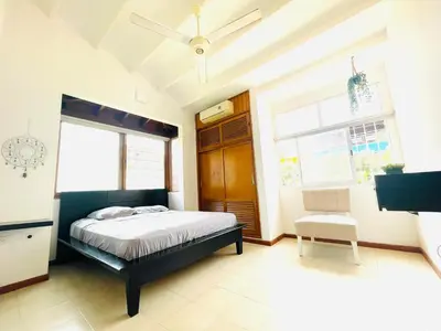 a bedroom with a bed and a ceiling fan at Casa de playa en Bello Horizonte a una cuadra del mar in Santa Marta
