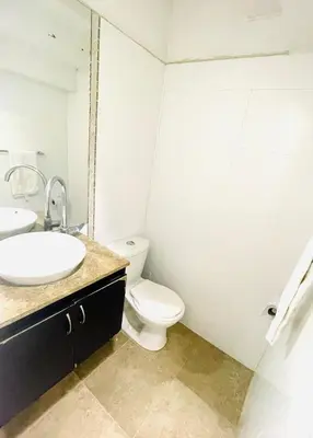 a bathroom with a white toilet and a sink at Casa de playa en Bello Horizonte a una cuadra del mar in Santa Marta