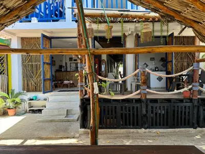 an entrance to a house with wooden beams at Hostel Beach House in Rincón