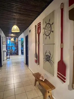 a hallway with tools on the wall and a bench at Hostel Beach House in Rincón