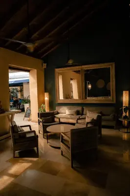 a living room with couches and a table and chairs at Nacar Hotel Cartagena, Curio Collection by Hilton in Cartagena de Indias