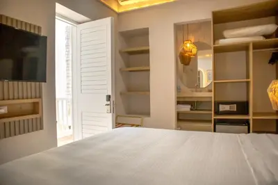a bedroom with a white bed and a tv at Hotel Casa La Mantilla by Faranda Boutique in Cartagena de Indias