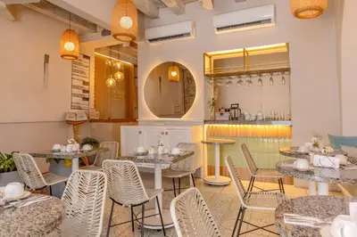 a restaurant with tables and chairs and a counter at Hotel Casa La Mantilla by Faranda Boutique in Cartagena de Indias