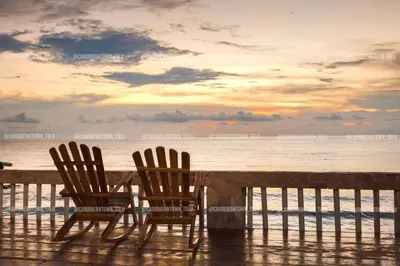 two chairs and a table on the beach with the ocean at Caribbean Town Tolu in Tolú