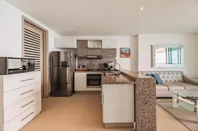 a kitchen and living room with a counter top at Palmetto Beach by MOME in Cartagena de Indias