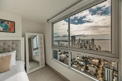 a bedroom with a window with a view of the city at Palmetto Beach by MOME in Cartagena de Indias