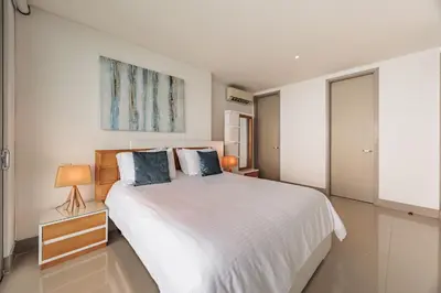 a bedroom with a large white bed with two pillows at Palmetto Beach by MOME in Cartagena de Indias