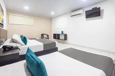 a bedroom with two beds and a tv at Hotel Ancor in Sincelejo