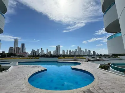 a large swimming pool with a city in the background at Apartamento semi penhouse in Cartagena de Indias