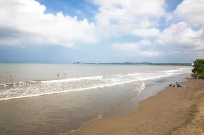 a beach with people standing in the water at Estelar Playa Manzanillo - All inclusive in Cartagena de Indias