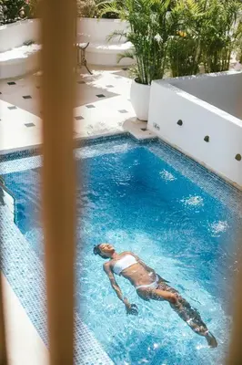 a woman swimming in a swimming pool at Amarla Boutique Hotel Cartagena in Cartagena de Indias