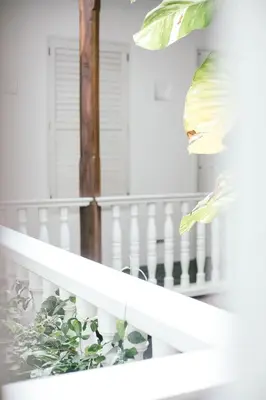 a white staircase with a white railing and a plant at Amarla Boutique Hotel Cartagena in Cartagena de Indias