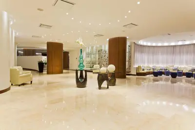 a lobby of a hotel with a table and chairs at Holiday Inn Cartagena Morros by IHG in Cartagena de Indias