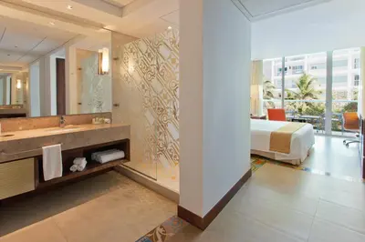 a bathroom with a sink and a bed in a room at Holiday Inn Cartagena Morros by IHG in Cartagena de Indias