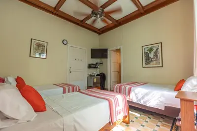 a bedroom with two beds and a ceiling at La casa azul in Cartagena de Indias