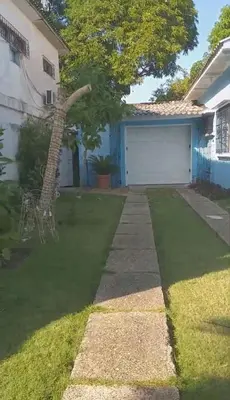 a house with a tree and a garage at La casa azul in Cartagena de Indias