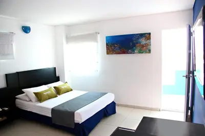 a hotel room with a bed and a window at Ayenda 1801 El Oceano in Cartagena de Indias