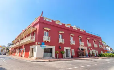 a red building on the corner of a street at GHL Collection Armería Real Hotel in Cartagena de Indias