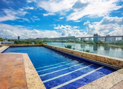 a swimming pool with a view of a river at GHL Collection Armería Real Hotel in Cartagena de Indias
