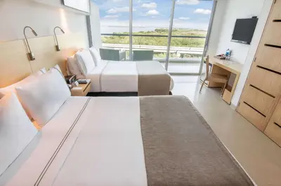 a hotel room with two beds and a large window at Sonesta Hotel Cartagena in Cartagena de Indias