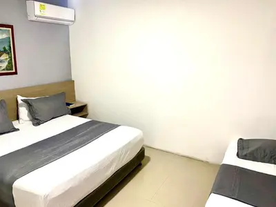 a bedroom with two beds in a room at Hotel Yivinaca in Barranquilla