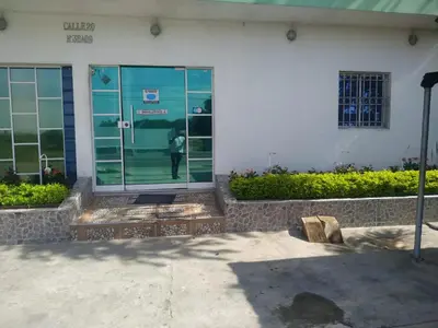 a man standing in the door of a building at Hotel Troncal Del Caribe in Ciénaga