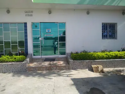 a person standing in the door of a building at Hotel Troncal Del Caribe in Ciénaga
