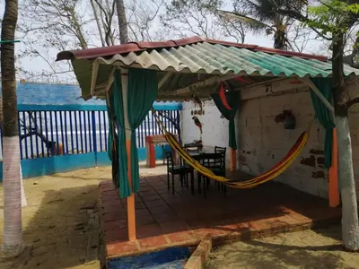 a gazebo with a hammock under a roof at Villa mar in Puerto Colombia