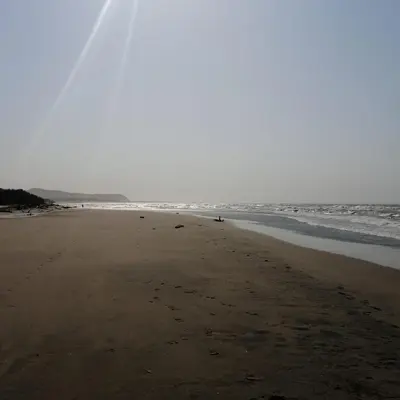 a beach with a person walking on the sand at Villa mar in Puerto Colombia