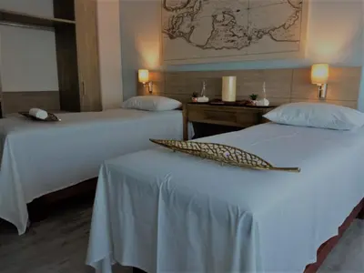a hotel room with two beds with white sheets at Holiday Inn Express Cartagena Manga by IHG in Cartagena de Indias