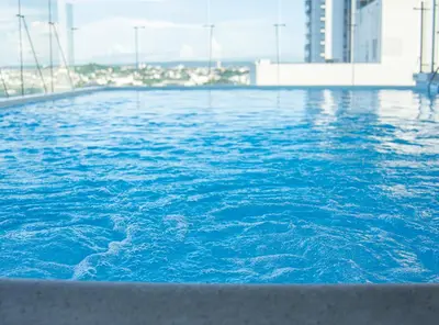 a large pool of blue water with buildings in the background at Holiday Inn Express Cartagena Manga by IHG in Cartagena de Indias