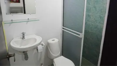 a bathroom with a sink and a toilet and a shower at Hotel Casa Paraiso in Barranquilla