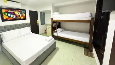 a room with two bunk beds and a mirror at Hotel Casa Paraiso in Barranquilla